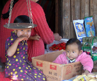 Lady with baby in a cardboard box in Yunan, China.